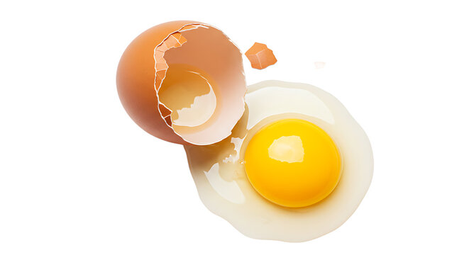 A cracked brown egg with the yolk and shell isolated on a black background in a studio shot