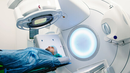 A patient undergoing radiation therapy. Medical linear accelerator in therapeutic oncology. The...