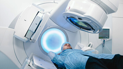 Modern approaches to oncology treatment. A man undergoes radiation therapy for cancer in a modern...