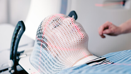 A patient undergoing radiation therapy. Medical linear accelerator in therapeutic oncology. The...