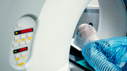 A patient undergoing radiation therapy. Medical linear accelerator in therapeutic oncology. The...