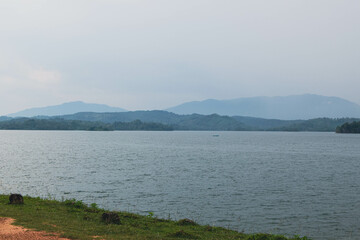 Blue Lake Surrounded by Lush Green Trees and Vines. Tranquil Forest Lake with Crystal Blue Water and Natural Foliage. Beautiful Blue Water Lake in the Heart of a Green Forest. Asian Lake Landscape