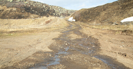  Dirty and muddy ground road in the nature at spring time.