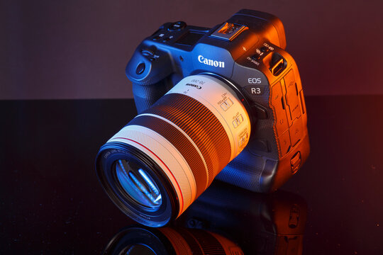 Milan, Italy - April 05, 2025: close up on Canon EOS flagship camera, R1 R3 size on a black background.