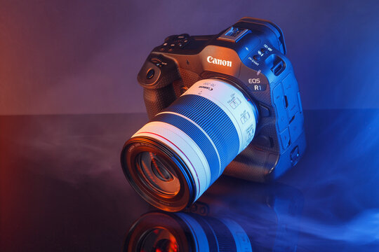 Milan, Italy - April 05, 2025: close up on Canon EOS flagship camera, R1 R3 size on a black background.