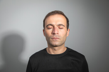 Caucasian man with a closed eyes.