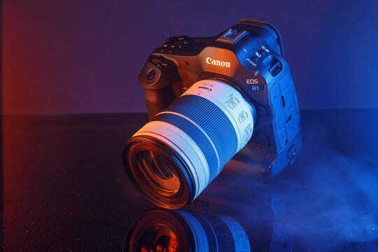 Milan, Italy - April 05, 2025: close up on Canon EOS flagship camera, R1 R3 size on a black background.