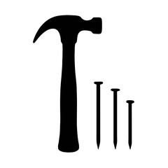 Hammer and nails showcase essential tools for construction and woodworking tasks at a workshop setting during daylight hours