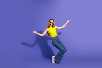 Vibrant Young Woman Posing Playfully Against a Purple Background Displaying Confidence and Stylish Fashion in Casual Attire