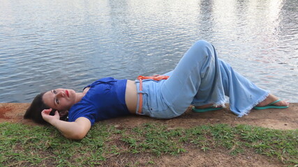 young woman lying on the grass