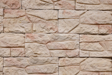 Textured stone wall featuring a natural, rustic design with warm tones and intricate patterns in a contemporary setting