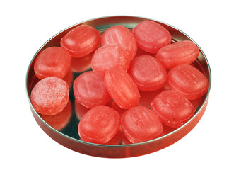 Red candies in the round metal box isolated on white background