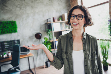 Young female specialist in stylish office representing success in programming and technology,...