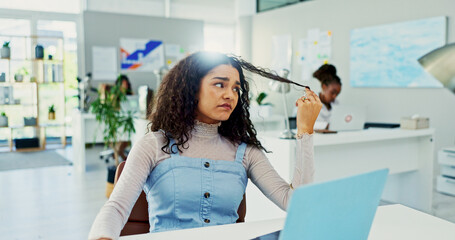 Obraz premium Bored, frustrated and woman in office with laptop, checking hair and waiting for email at digital agency. Thinking, tired and designer at desk with burnout, brain fog or irritated with online project