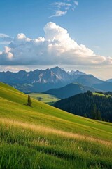 Obraz premium grassy field with mountains in the distance and a few clouds in the sky