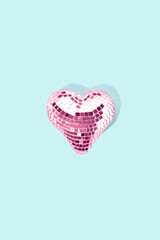 Heart shaped disco ball on blue background. Party concept.