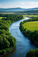 Fototapeta premium arafed view of a river running through a lush green field