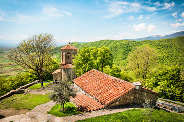 Stunning landscape of Nekresi Monastery with ancient architecture set against lush mountains in Kakheti, Georgia