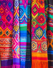 The vibrant colors and geometric patterns of Ikat textiles from different regions of India are displayed, showcasing the diverse weaving traditions and artistry.