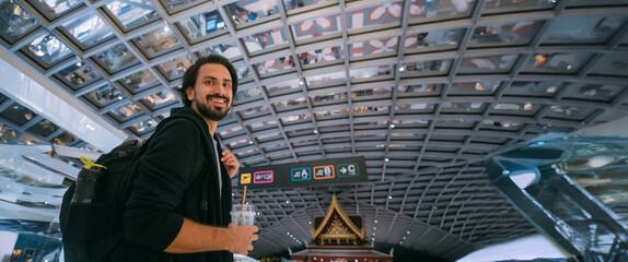 Young man with a backpack at the airport.