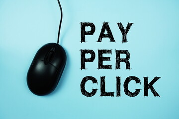 Pay Per Click text with optical mouse on blue background