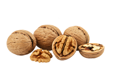 A close up shot of several walnuts including whole and halved on a black background space for text