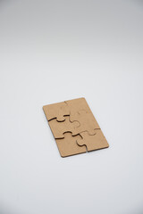 Puzzle pieces in a pile on a white background. Close-up
