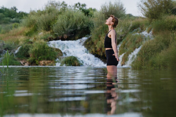 Fototapeta premium Young woman practicing yoga on nature. Holistic Health & Mental Well-Being.