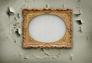 Empty canvass in old golden round frame on a grunge wall