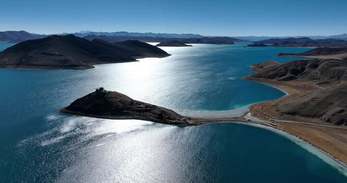 Aerial footage of ancient temple and beautiful Yamdrok Yumtso lake in Tibet, China