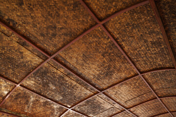 Wood texture background showing traditional weaving roof structure, with interlaced wooden strips forming natural patterns and an organic rustic look.