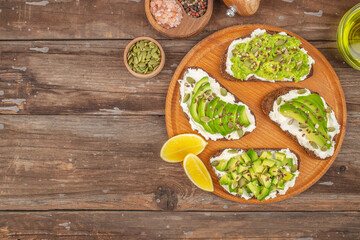 Sandwich with avocado and seeds on the wooden table, Healthy food, keto diet, diet lunch concept. top view. place for text