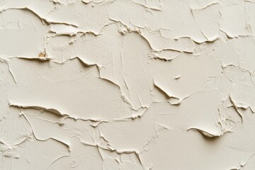 A close-up of a white textured wall with irregular patterns and crevices