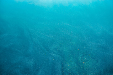 blue Shiny Abstract Background. Paints, Acrylic, Glitter in Water.