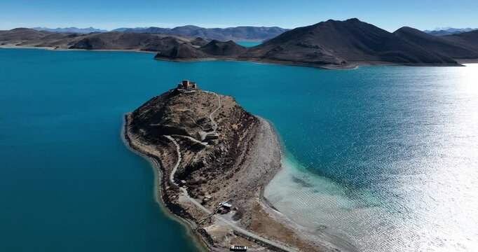 Aerial footage of ancient temple and beautiful Yamdrok Yumtso lake in Tibet, China