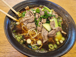 A delicious and comforting bowl of noodle soup made with tender beef and fresh green onions