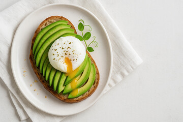 Avocado Toast with Poached Egg and Microgreens on Ceramic Plate. Top View of fresh Healthy Breakfast in Natural Light on a linen towel and white background. food concept with copy space