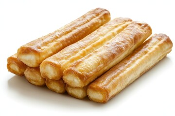 Delicious crispy churros stacked on a white surface showcasing their golden brown texture in a bright studio shot perfect for culinary themes