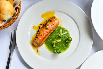 Salmon steak on a white plate ready to eat Italian style
