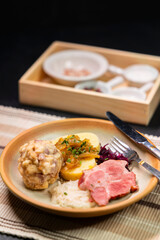 Bavarian dumplings with roasted pork, sauerkraut and potato dumpling lying on a plate