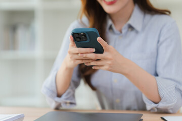 Woman Using Smartphone at Desk