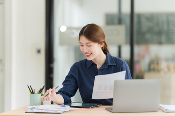 Fototapeta premium Smiling Young Woman Analyzing Business Data
