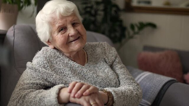 Elderly woman sitting in armchair
