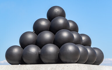 A pyramid of black solid shots