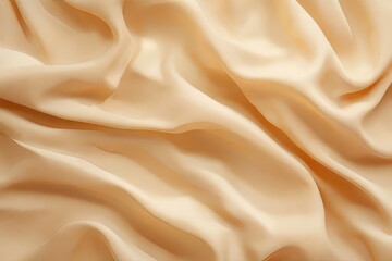 Obraz premium Close-up view of a soft, peach-toned fabric draped in elegant folds.