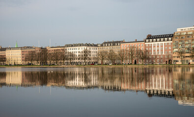 Obraz premium Waterfront Residential Buildings Reflected in Water on a Spring Day, Copenhagen, Denmark, 16 April 2018