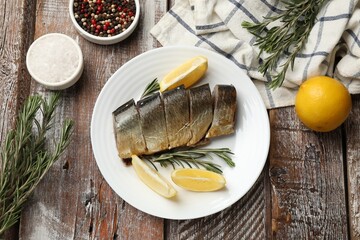 Smoked herring and spices on wooden table, flat lay