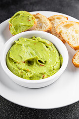 Guacamole dip avocado sauce cold appetizer vegetable pate dish organic product fresh tasty gourmet food background on the table rustic food top view copy space 