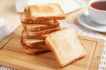 Slices of tasty toasted bread on table, closeup
