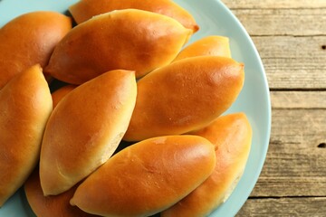 Tasty baked patties on wooden table, top view